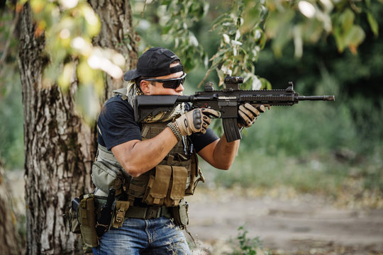 Terrorist aiming his rifle on battlefield background