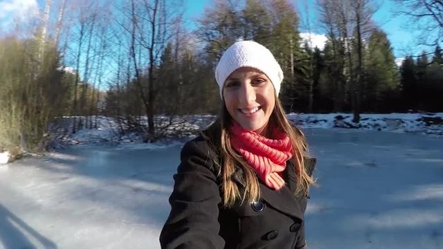 CLOSE UP: Young woman ice skating outdoors selfie