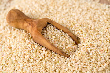 sesame seeds in a wooden scoop