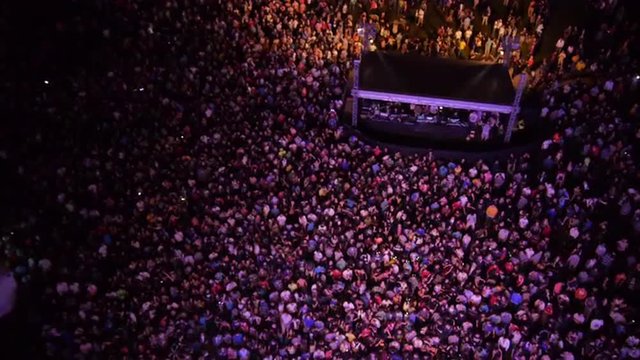 AERIAL: People partying on a outdoors music concert