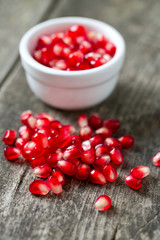 pomegranate seeds on wooden surface