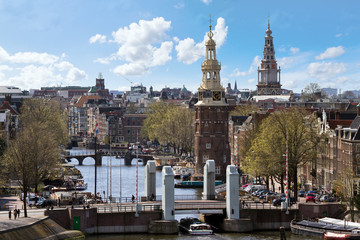 Fototapeta premium Amsterdam skyline with the Montelbaanstoren at the Oudeschans and the Zuiderkerk church