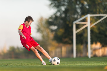 kid kicking a soccer ball © Dusan Kostic