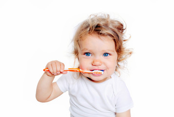Curly baby toddler brushing teeth.