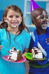 Happy kids eating birthday cake