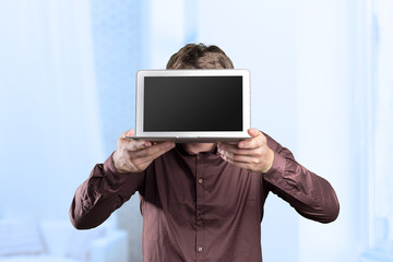 Young man holding laptop