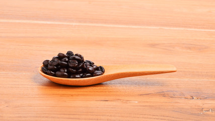 Coffee beans in wooden spoon