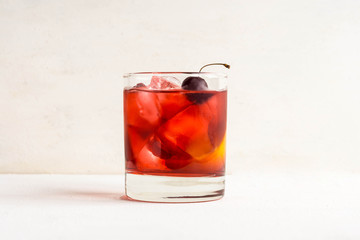 Old fashioned cocktail on white wooden background