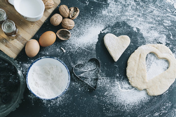 above view of a table with cookie cutter flour and various ingredients