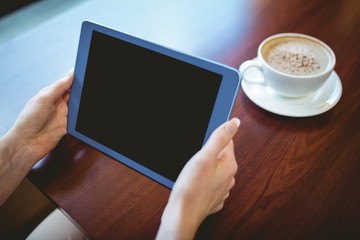 Fototapeta na wymiar Mature student using tablet in cafe
