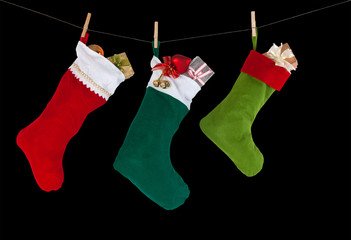 Christmas socks hanging on the rope. black background. isolated