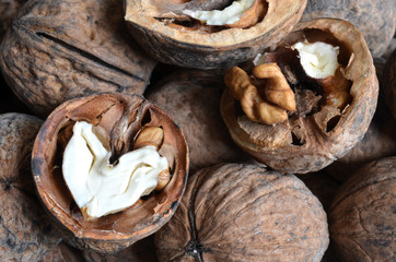 core walnut in the form of heart on the background of walnuts in shell  
