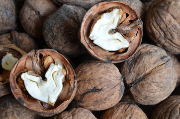 core walnut in the form of heart on the background of walnuts in shell  
