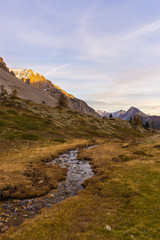 High altitude alpine stream in autumn season