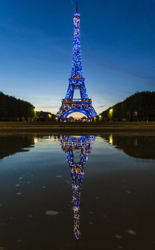 Colored lights illuminate the Eiffel Tower, Champ de Mars, Paris, France
