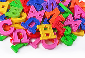 Colorful plastic alphabet letters on a white