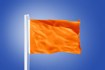 Orange flag flying against clear blue sky
