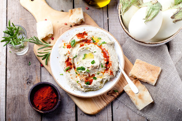 Traditional arabian eggplant dip baba ganoush with herbs, smoked paprika