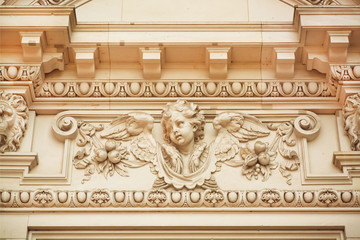 Face of angel on facade of historical building