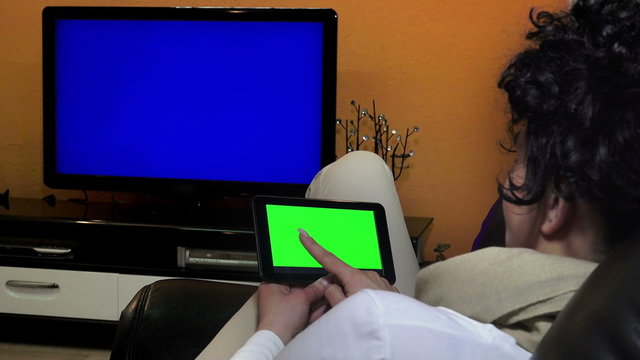 Back view of woman at home using 
