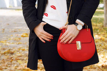 Fashion girl with red leather handbag. Trendy accessories