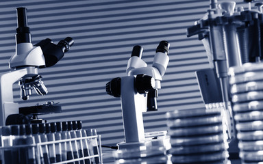 Laboratory work place with microscope, test tube and pipettes.
