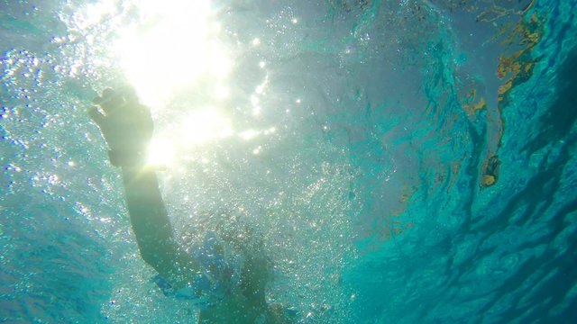 Underwater view of child swimmin with inflamable 