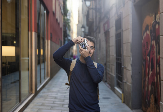 Young man taking photos in Barcelona