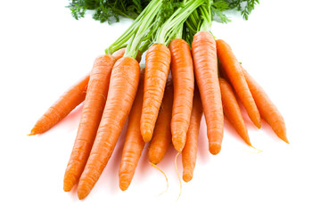 Bunch of fresh carrots with green tops. Isolated on a white.