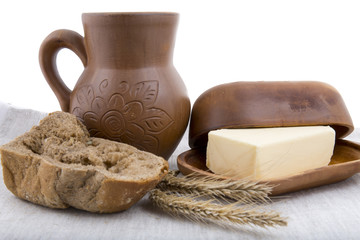 fresh milk, butter and rye bread in-kind pottery on linen tablec
