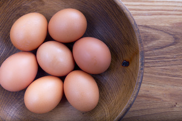 brown eggs in a wooden plate