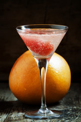 Pink cocktail with grapefruit and soda in a martini glass, selec