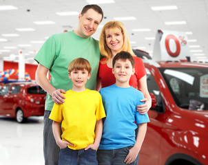 Happy family near new car.