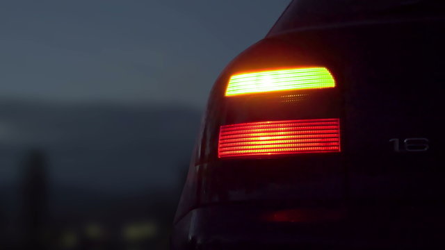 Sport car with hazard lights near the 