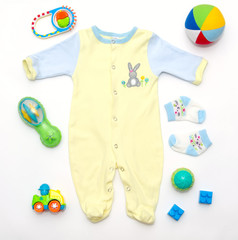 top view of baby boy yellow-blue clothes and toy stuff