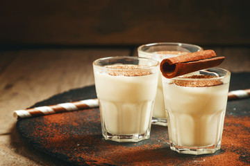 Traditional winter eggnog  with milk, rum and cinnamon, sprinkle