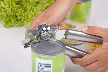 woman hands using a can opener