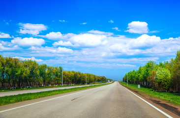 Fototapeta premium Highway in the summer with clouds and bright light