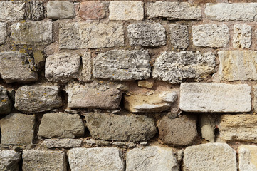 The walls are built of stone blocks and wooden spacers