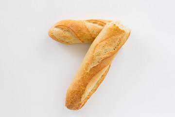French bread baguette on a white background, made from flour. baking, top view, side view. space...