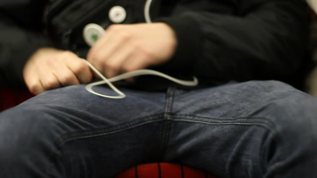Youngster listens to mp3 on his cellphone