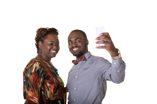 A mother and her son taking a picture of themselves on a cell phone