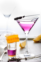 Martini, lavender, honey, lemon cocktail on a white background. Vermouth.