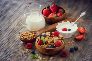 Fresh healthy breakfast with granola and berries, wooden backgro