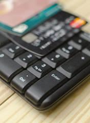 Obraz premium close up of a computer keyboard with credit card on top. focus on enter button