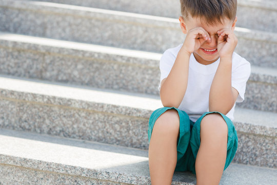 The boy sitting on the stairs in the underpass - Powered by Adobe