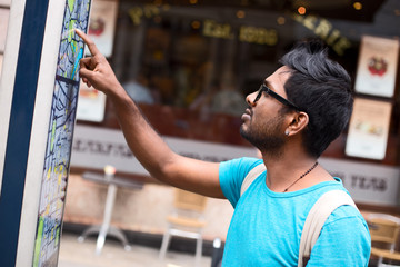 tourist looking at a map in the street
