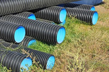 Stacked new PVC pipe on construction site