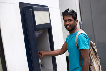 young man at the cash machine