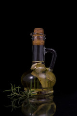 Obraz na płótnie Canvas appetizing bottle of olive oil infused with rosemary, spices, ga